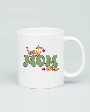 Aviza Best Mom Ever Groovy Mug featuring a sage green and tan retro bubble font design with small red heart accents on a white ceramic base.