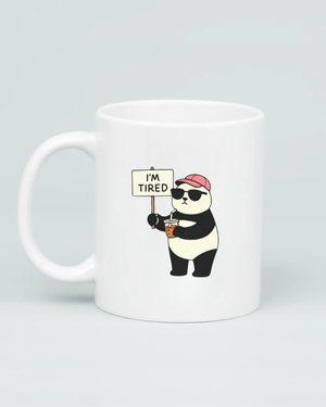White coffee mug featuring a cartoon panda wearing sunglasses and a pink hat, holding a coffee and an 'I'm Tired' sign, on a clean grey background.