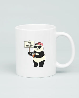 White coffee mug featuring a cartoon panda wearing sunglasses and a pink hat, holding a coffee and an 'I'm Tired' sign, on a clean grey background.